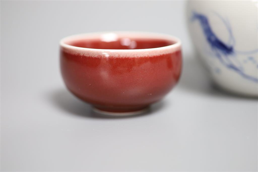 A Chinese blue and white water pot and two sang de boeuf glazed cups, tallest 9cm